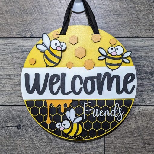 Buzzing with Warmth: Welcome Friends Cartoon Bee Door Hanger | Laser Cut Wood Sign